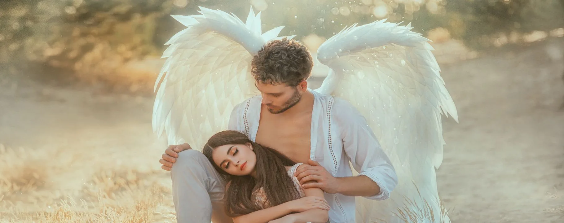 What angel means: the guardian angel who protects and accompanies Guardian angel with large white wings embracing and protecting a sleeping woman